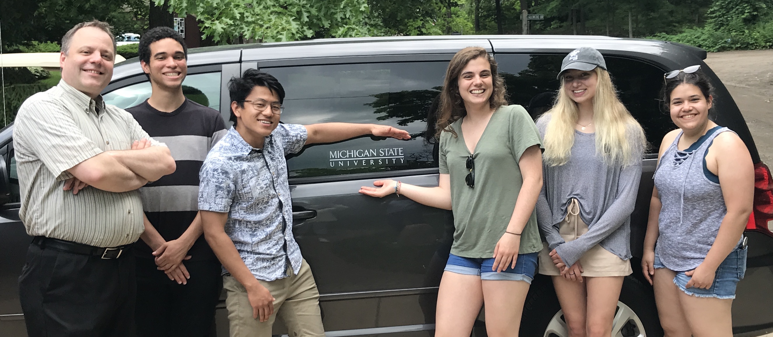 Research group in front of college van